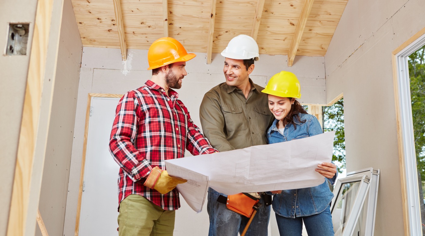 Craftsman and artisans cooperating and planning in teamwork at building construction