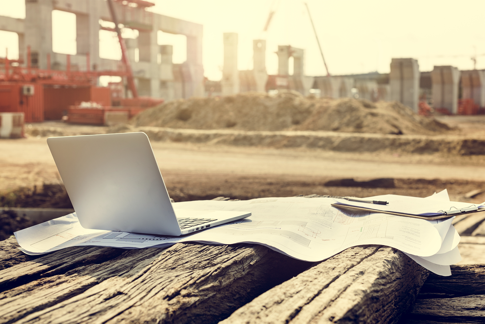 Laptop at land clearing for planning for Commercial Building Construction: Site Development 