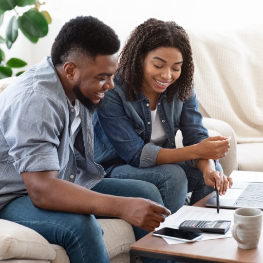 Household Budget. Smiling Black Couple Discussing Total Amount Of Their Spends At Home, Happy About Wise Planning