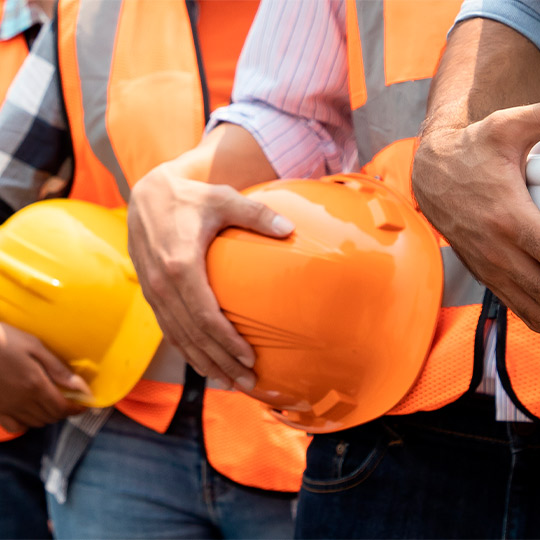 builders contractor with safety chest and helmets