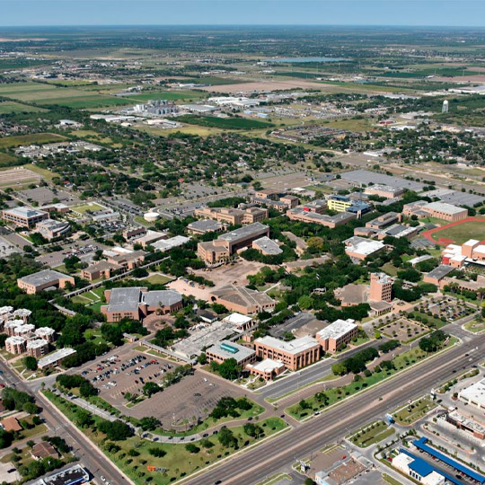 Aerial view of the University of Texas at Austin campus, showcasing its buildings and green spaces.