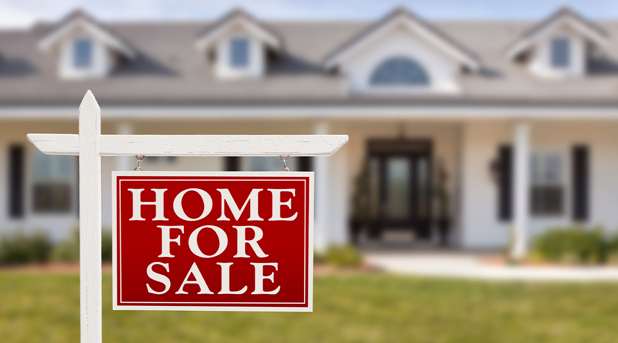 Home for sale sign displayed in front of a house, highlighting opportunities in the Texas real estate market.