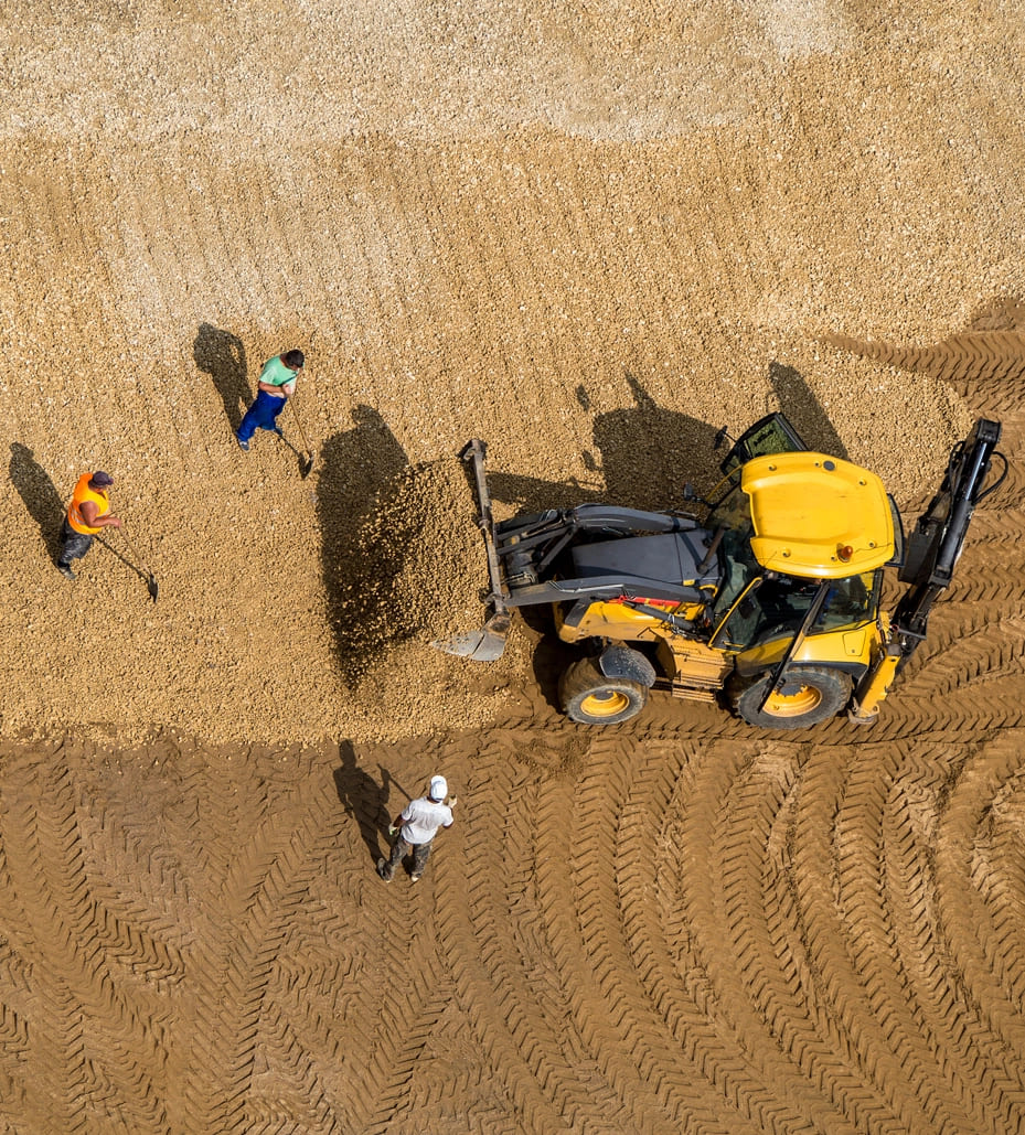 Team of construction workers engaged in site preparation and dirt work at a Liongate Builders project in McAllen, Texas.