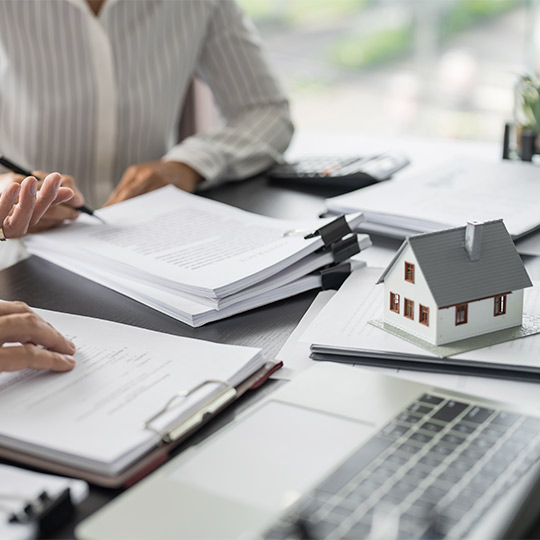 A real estate agent assists a client with a contract, highlighting the steps for first-time home buyers in South Texas.