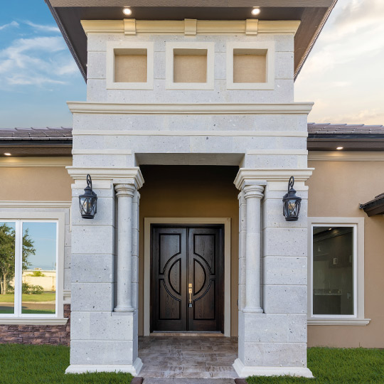 A stylish home featuring a prominent front door and elegant columns, reflecting McAllen, TX's 2026 design trends.