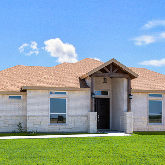 Exterior view of a large house surrounded by a vast yard, reflecting 2026 design trends for McAllen, TX residences.