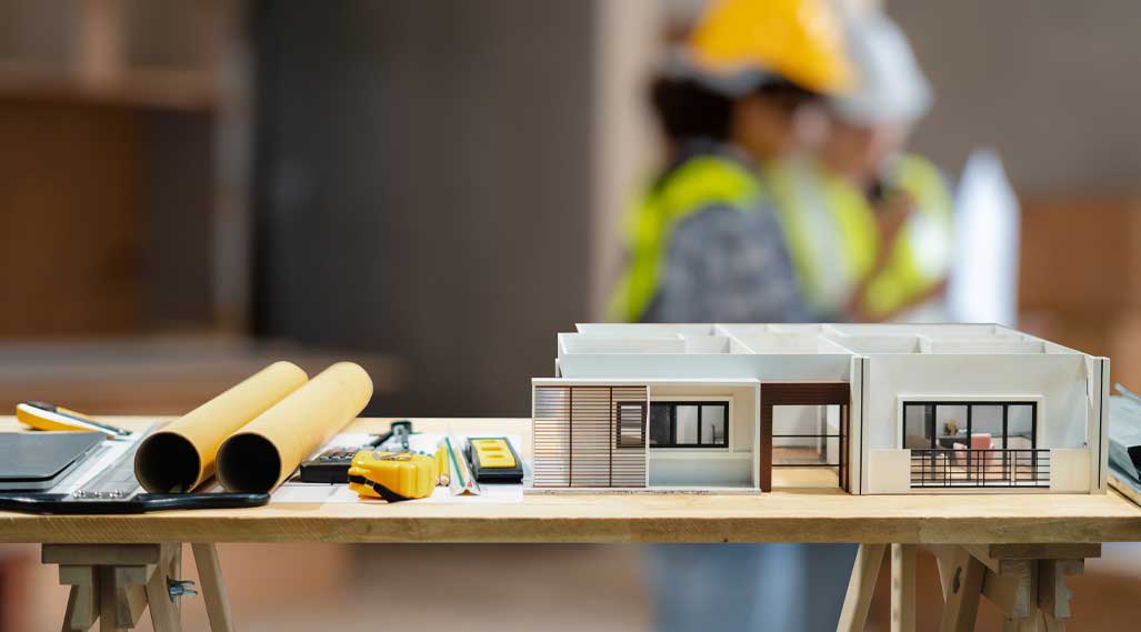 Construction house and building. Repair work. dof laptop computer and office construction on table in office blurred background.Architect concept.